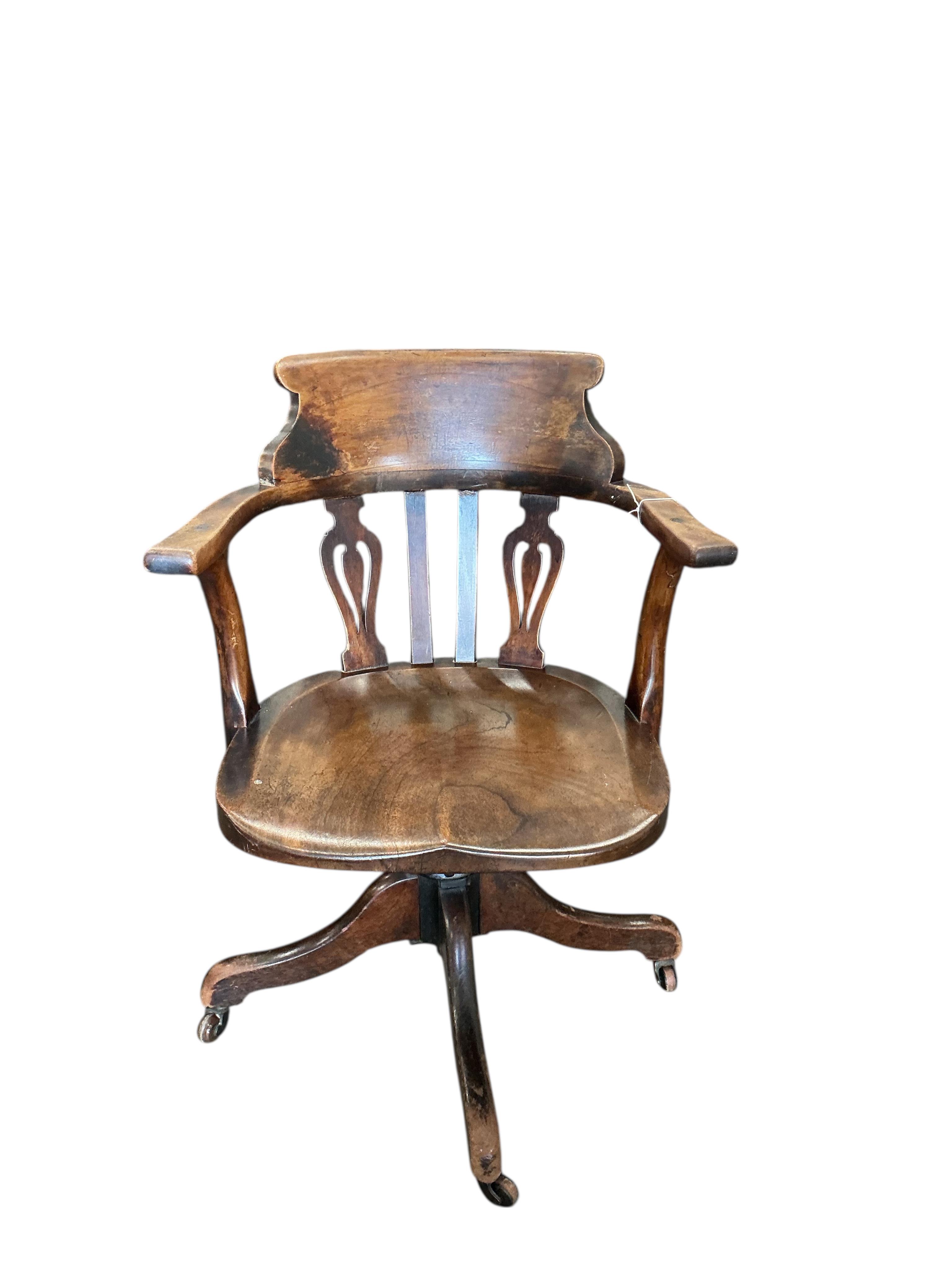 A Victorian mahogany swivel desk chair with saddle seat, width 59cm, depth 48cm, height 81cm